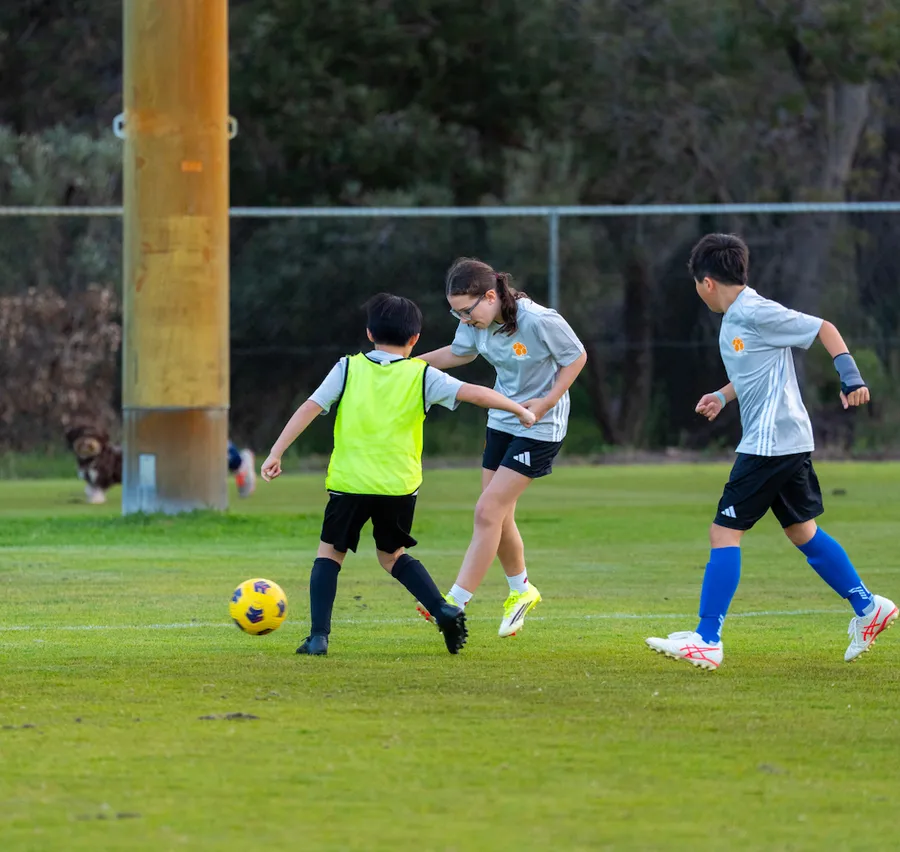 Players challenging for the ball together at training
